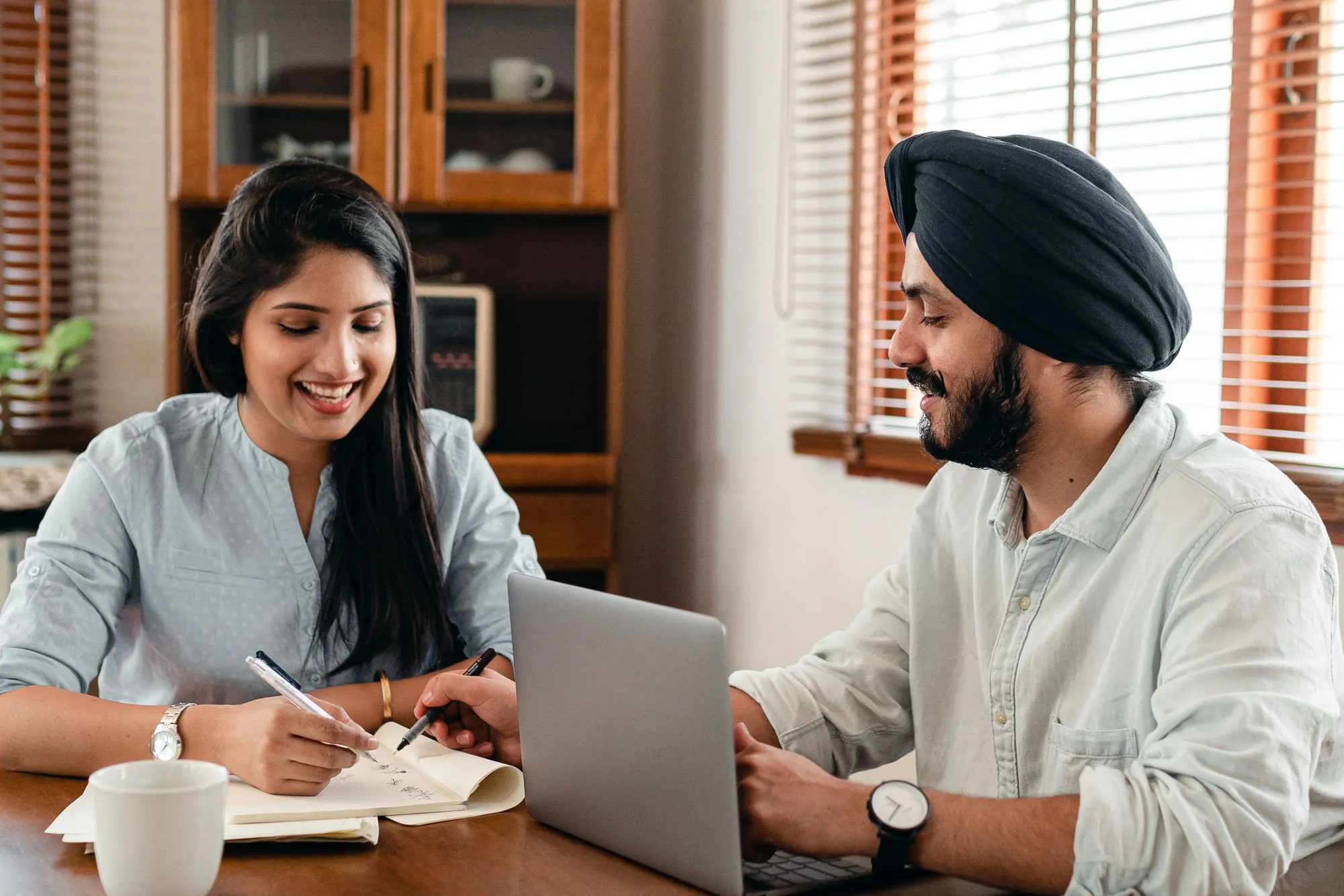 Two learners working through an online course on a laptop